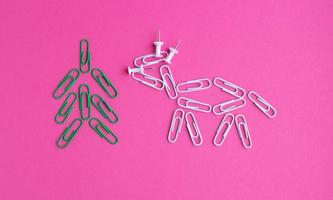 Year of the bull 2021.Colorful paper clips isolated on a pink background. Office supplies. Stapling documents and paper with paper clips. photo