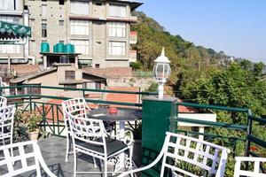 Early morning view of Modern rooftop restaurant at Kasauli, Himachal Pradesh in India, View of mountain hills from open air restaurant in Kasauli, Kasauli Rooftop restaurant photo