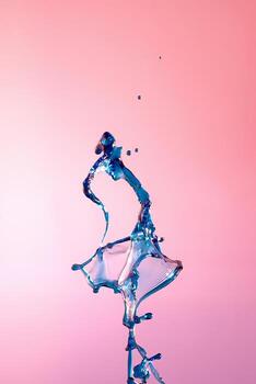 Abstract background of a splash of colored water, collision of colored drops falling towards each other. photo
