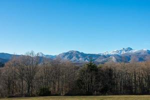 snow capped mountains with blue sky photo