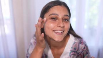 Young beautiful woman applies under eye mask video