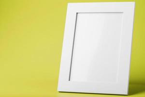 White photo frame on yellow background with free space.