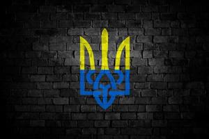 Flag of Ukraine on Brick Wall, Triden Coat of Arms Industrial Graphic, Symbol of Freedom, Grunge Style Picture, Fight in War with Russia, Symbolic Image, Texture on urban surface, Patriotic background photo