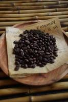 High angle view of coffee beans on wooden plate. photo