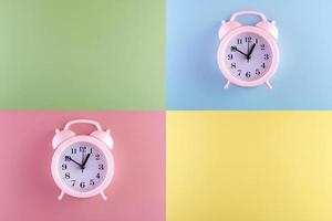 alarm clock on pastel color background in copy space. photo