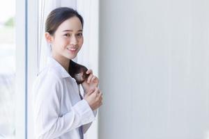 Asian beautiful woman has black long hair in white shirt. photo