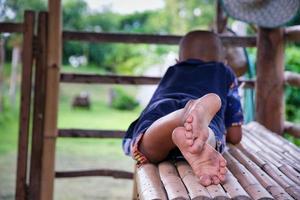 A boy's dusty feet lie in a pavilion with empty spaces for messages. photo