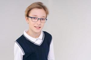 Shrugging caucasian boy, doubting shrugs, School boy, teenager with glasses photo