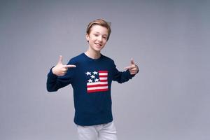 Portrait positive european guy, in blue sweater with usa flag, cheerful bright photo