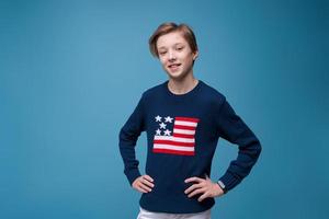 Portrait positive european guy, in blue sweater with usa flag, cheerful bright photo