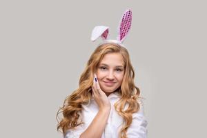 Cute beautiful girl wearing cute pink easter bunny ears, with impatience photo