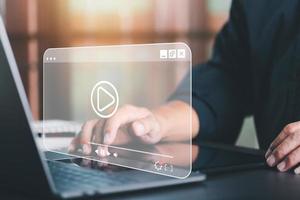 young man using laptop to watch video,Training, learning, teaching, virtual reality used in online video conferencing,Online streaming Watch videos on the Internet photo