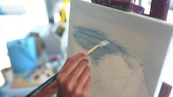 uma mulher pintando na aula de arte video