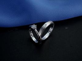 White gold wedding ring. couple ring with glossy and doff finishing with blue and black background photo