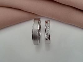 White gold wedding ring. couple ring with glossy and doff finishing with brown cloth background and white base photo