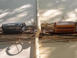 junction boxes of electrical and internet cables on a houses wall photo