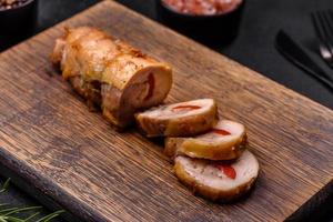 Tasty baked meat roll of chicken meat, sweet pepper with spices and herbs photo