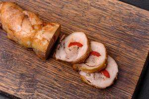 Tasty baked meat roll of chicken meat, sweet pepper with spices and herbs photo