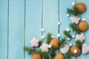 Christmas border with gingerbread, marshmallow and branch of fir tree photo