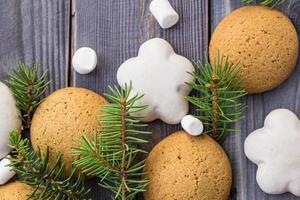 Christmas border with gingerbread, marshmallow and branch of fir tree photo
