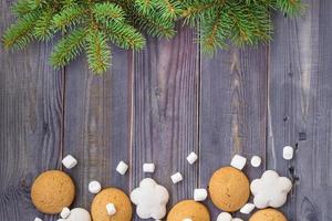 Christmas border with gingerbread, marshmallow and branch of fir tree photo