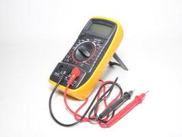 Digital multimeter with probes and display on a white background photo