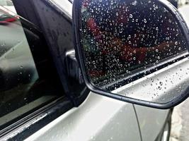 The dew that appears on the silver car rearview mirror due to the after-rain effect photo