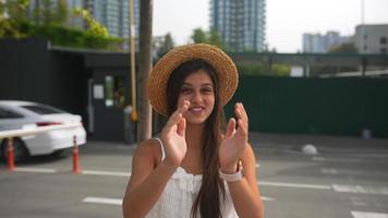 Woman in a flowy white dress walking on the street video