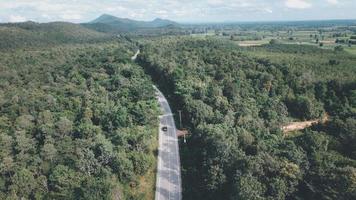 Arial view of a highway through a forest at sunset photo