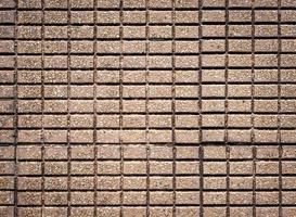 Texture of a sidewalk made from small rectangle bricks photographed from above photo