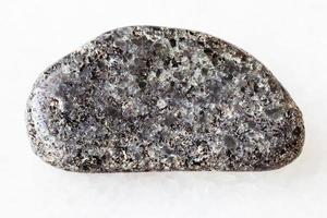 tumbled Peridotite stone with Phlogopite on white photo