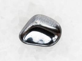 tumbled hematite gem on white marble photo