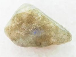 tumbled labradorite gemstone on white marble photo