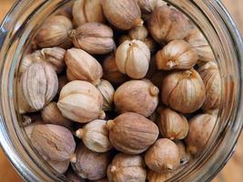 Close up dried cardamom in a glass jar photo