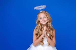 Postcard for valentine's day. Child in long white dress and with angel wings photo