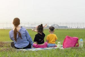 Mother and child watching planes take off and land their children's dreams of becoming pilots. family having fun. Children dream to fly and become a pilot. photo