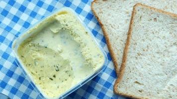 Bread slices and sandwich spread on a blue gingham picnic blanket video