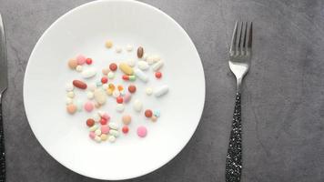 Overhead view of a dinner plate with pharmaceutical pills video