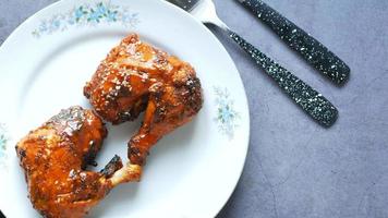 Crispy grilled chicken with sesame seeds on plate with fork and knife on table video