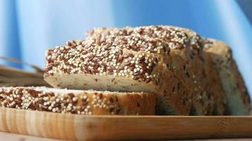 Seeded bread loaf sliced on cutting board video