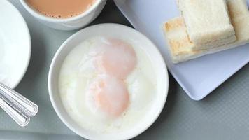 Overhead pan of breakfast foods including eggs biscuits and coffee video