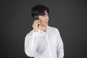 Business man wearing white shirt holding mobile phone. photo