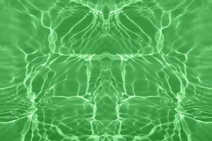 Defocus blurred transparent green colored clear calm water surface texture with splash, bubble. Shining green water ripple background. Surface of water in swimming pool. Green bubble water shining. photo