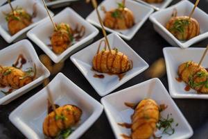 Delicious appetizer close-up friend shrimp dumpling with soya sauce and green salad. Gourmet appetizer bites, soft sunlight traditional asian cuisine photo