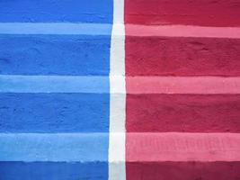 Close-up of blue and red concrete step wth white middle line photo