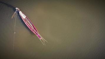 Aerial image, Fishing boat fishing in the lake in sunset time. photo