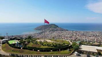 alanya vista superior na montanha com bandeira da turquia e fundo da cidade belo marco de viagem de paisagem de alanya turquia video