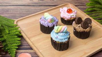 Colorful Cupcakes on wooden table  . photo