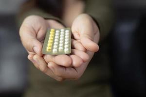 Women carry birth control pills, focus Hand photo