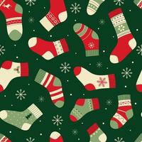 Seamless pattern with bright Christmas socks on a green background. Vector illustration for packaging, wrapping paper, testicle, fabric